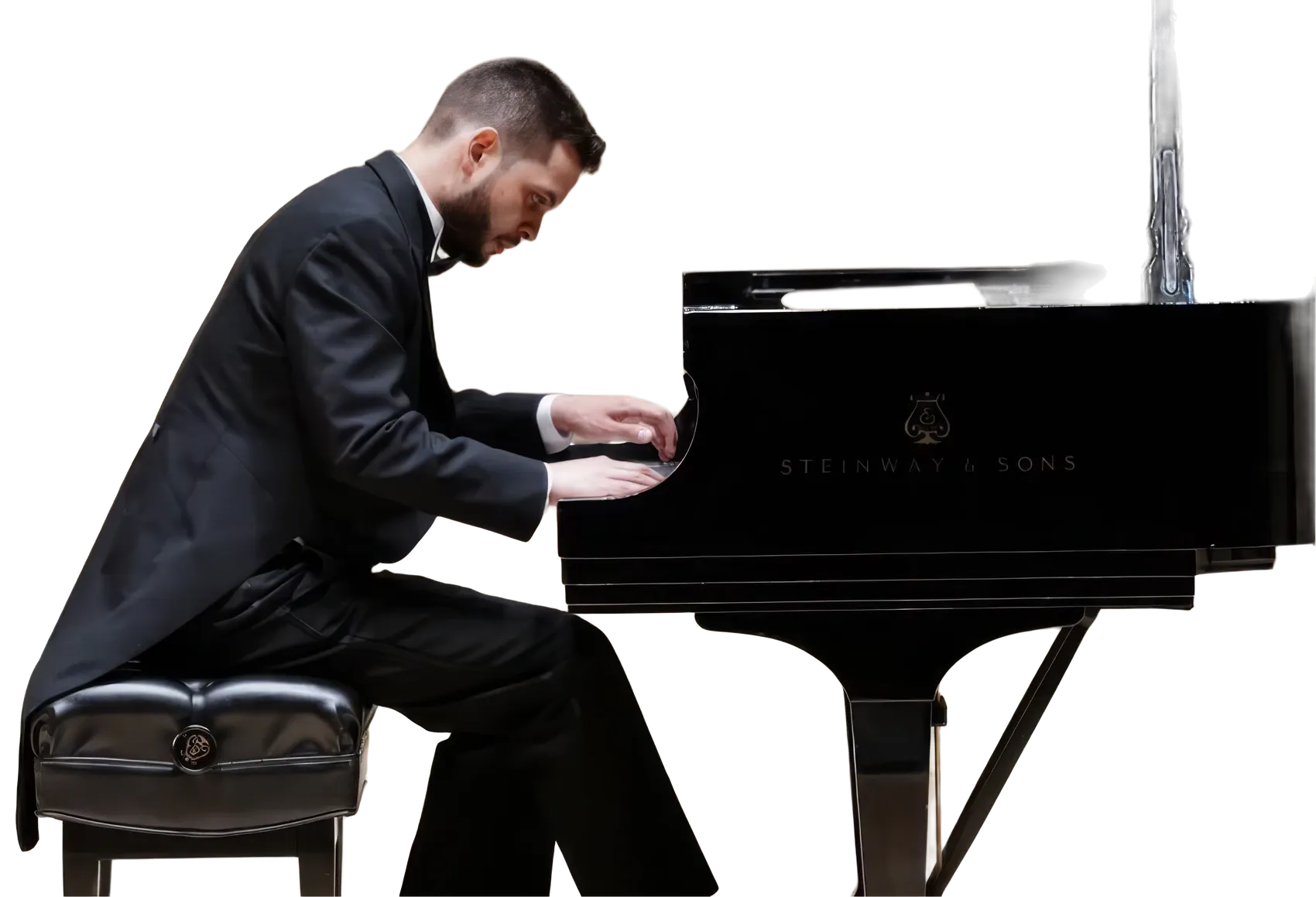 Johnson Gouvêa playing a Steinway grand piano in recital, in formal tails