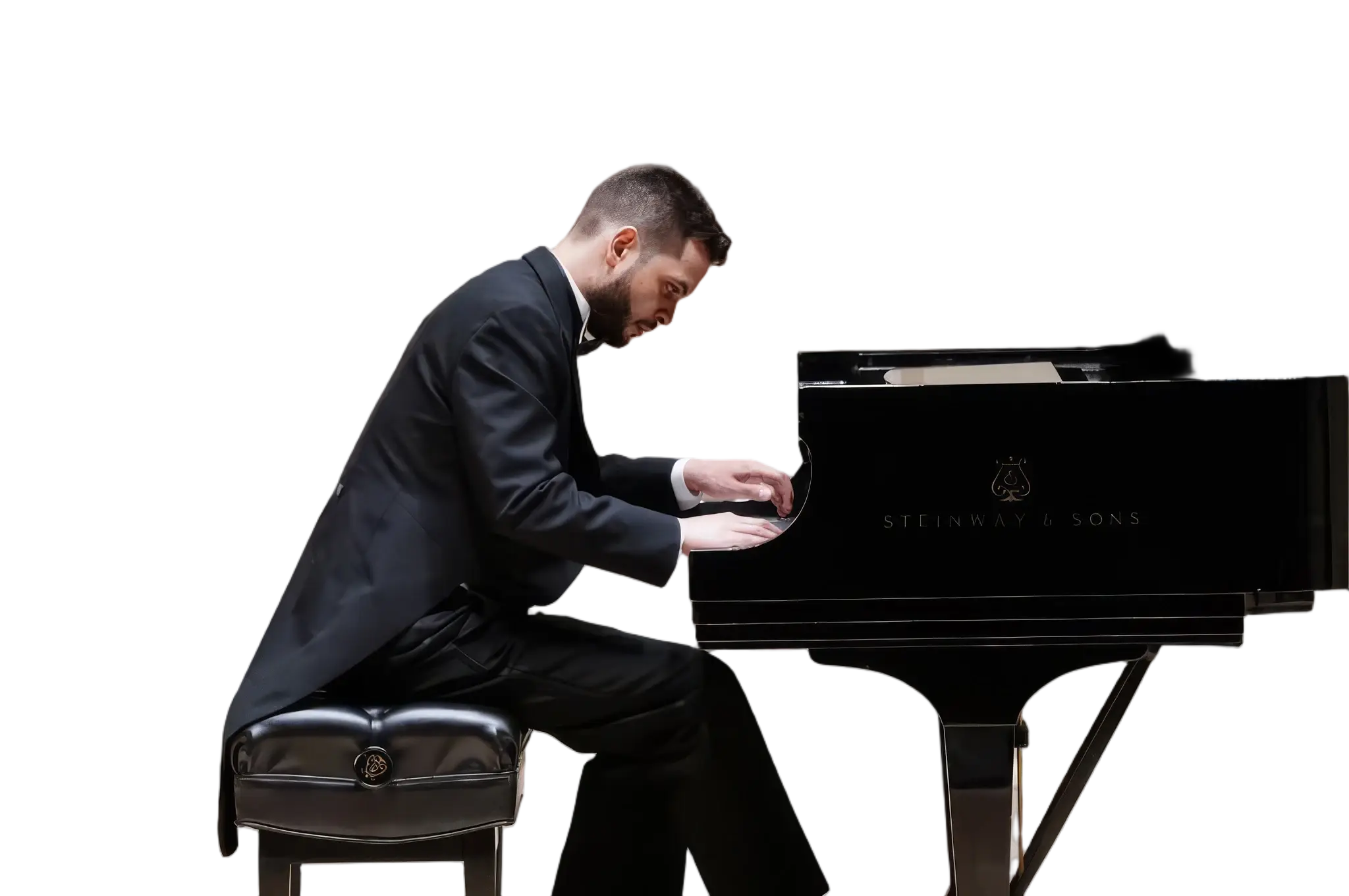 Johnson Gouvêa playing a Steinway grand piano in recital, in formal tails